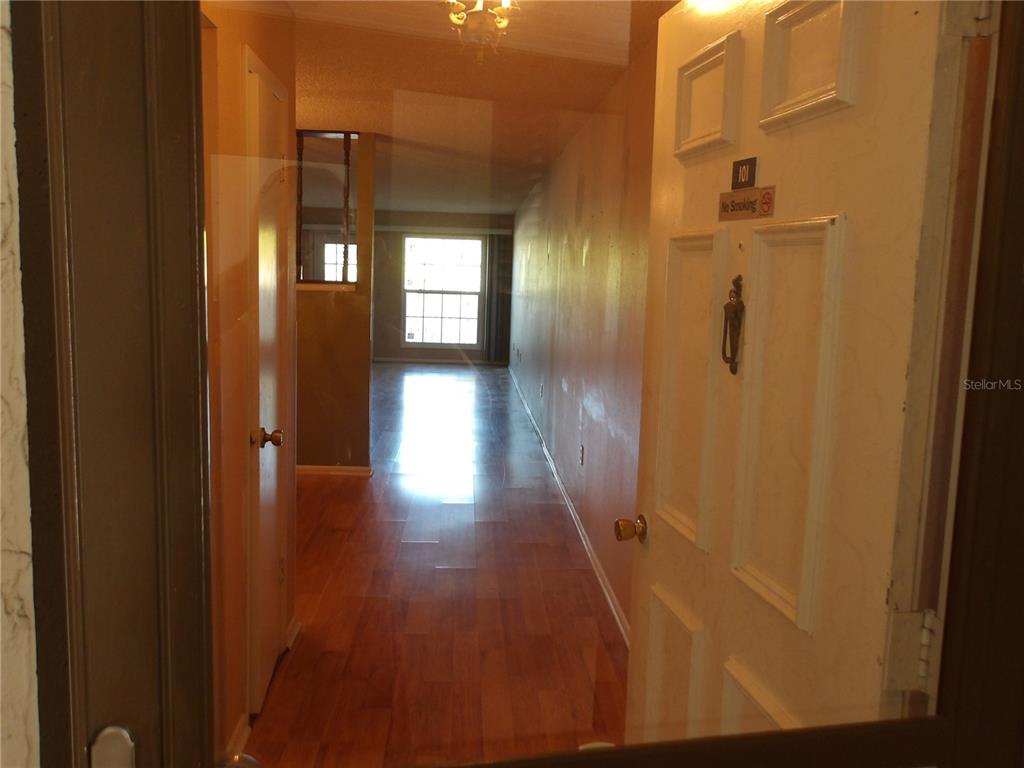 4140 Passport Lane, Unit 101 New Port Richey, FL 34653 - Photo 6 of 40 a view of a hallway with wooden floor