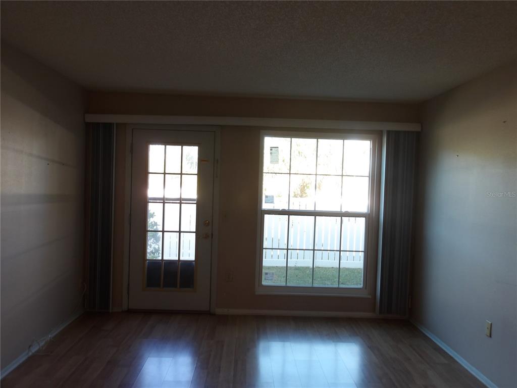 4140 Passport Lane, Unit 101 New Port Richey, FL 34653 - Photo 8 of 40 wooden floor in an empty room with a window