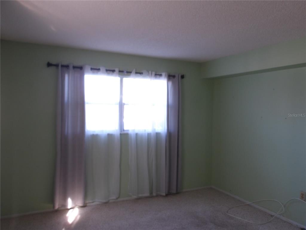 4140 Passport Lane, Unit 101 New Port Richey, FL 34653 - Photo 10 of 40 an empty room with a window