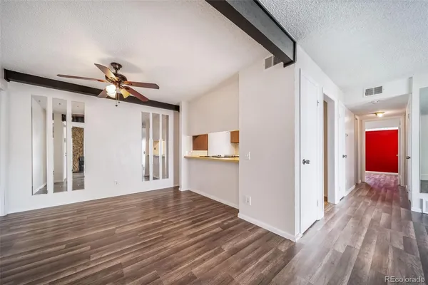 a view of a hallway with wooden floor and staircase