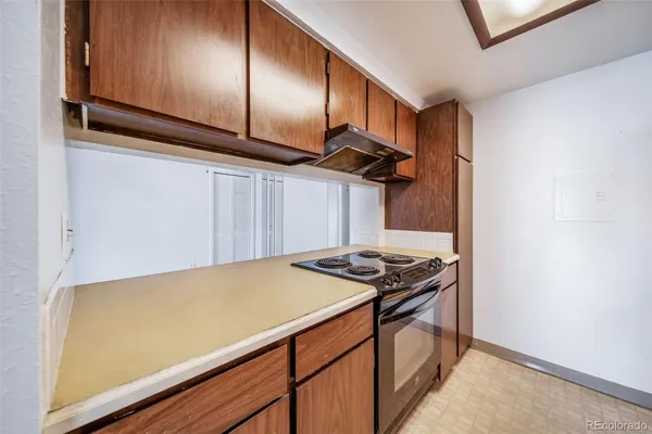 a kitchen with stainless steel appliances a stove a sink and cabinets