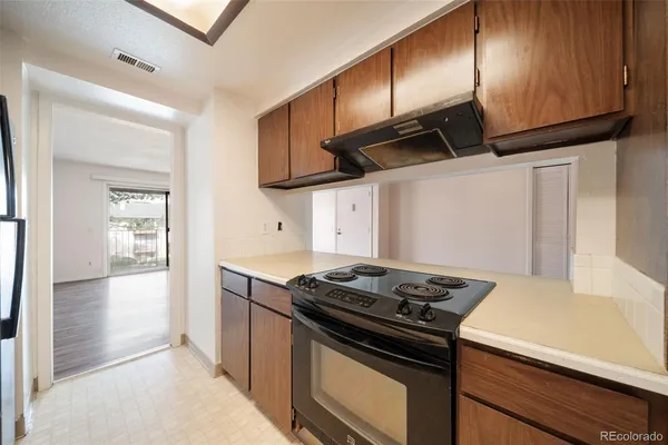 a kitchen with a stove and a refrigerator