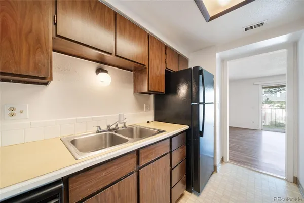 a kitchen with a sink and refrigerator