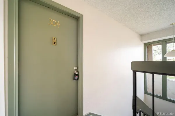 a view of a hallway with a door and a window