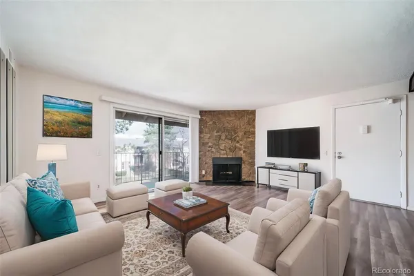 a living room with furniture fireplace and a flat screen tv