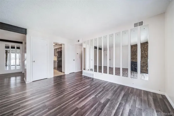 a view of wooden floor and windows in a room