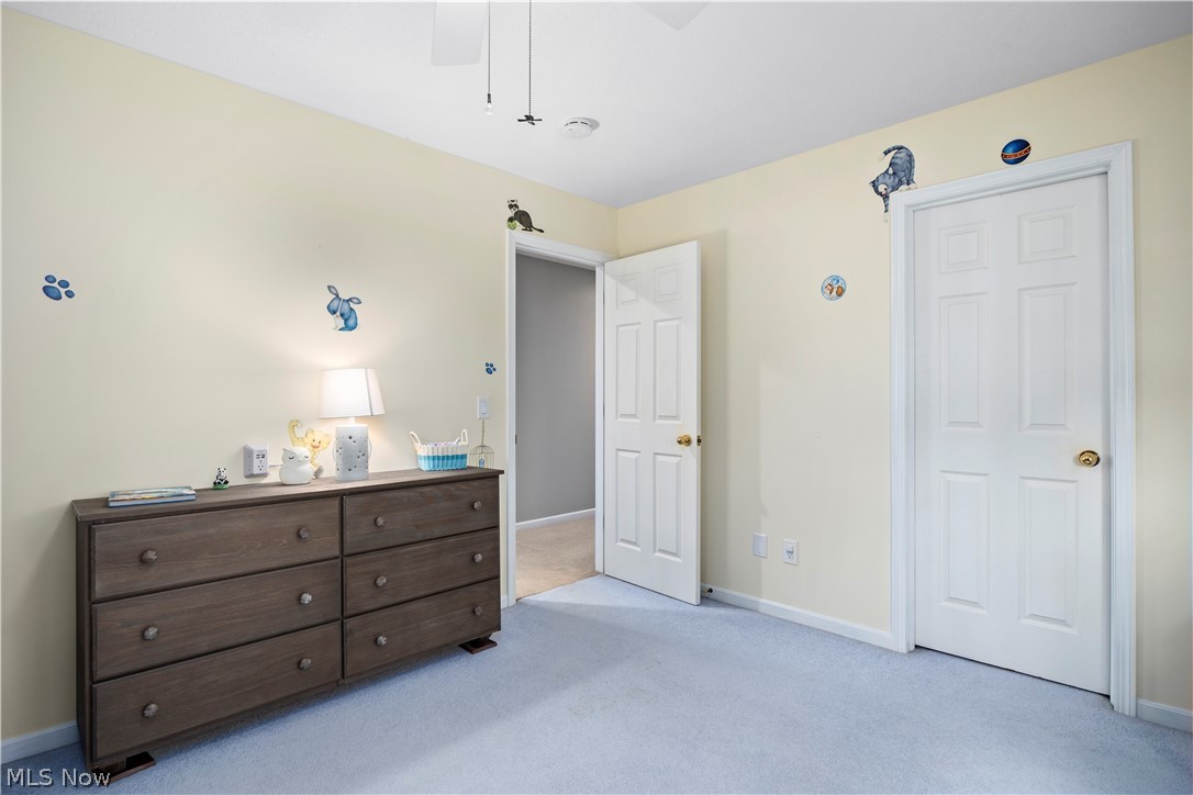 3270 North Ridge Road Vermilion, OH 44089 - Photo 38 of 49 Light-colored wall paint with white trim, light blue carpet flooring, and two paneled interior doors