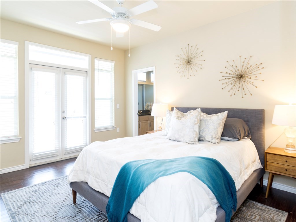 2606 Wilson Street, Unit 1601 Austin, TX 78704 - Photo 14 of 14 a bedroom with a large bed and a chandelier