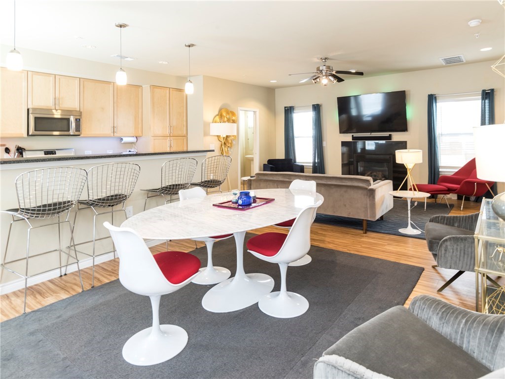 2606 Wilson Street, Unit 1601 Austin, TX 78704 - Photo 5 of 14 a large kitchen with a table and chairs