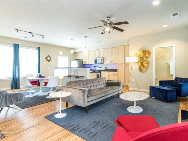 a living room with furniture and wooden floor