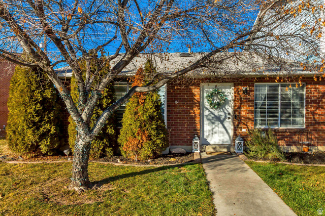 933 South Freedom Boulevard, Unit 7 Provo, UT 84601 - Photo 2 of 23 View of front of property featuring brick siding and a front yard