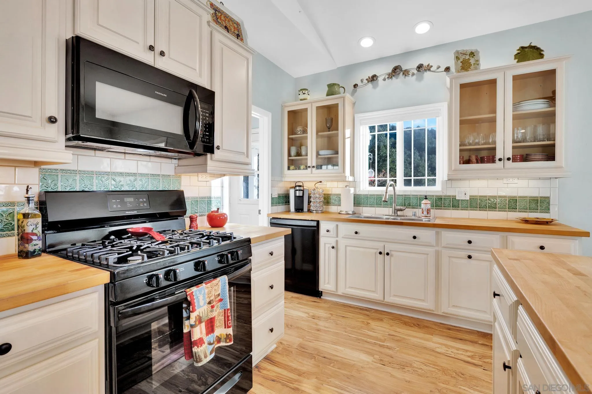 17735 Harrison Park Road Julian, CA 92036 - Photo 17 of 43 a kitchen with stainless steel appliances a stove a sink and a microwave