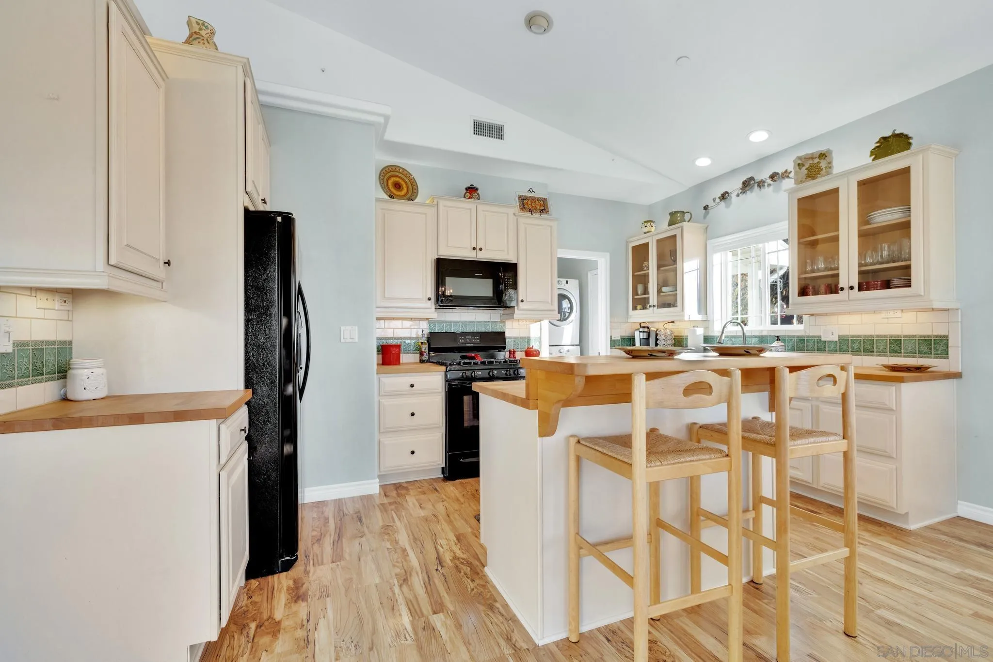 17735 Harrison Park Road Julian, CA 92036 - Photo 19 of 43 a kitchen with stainless steel appliances kitchen island granite countertop a refrigerator and a stove top oven