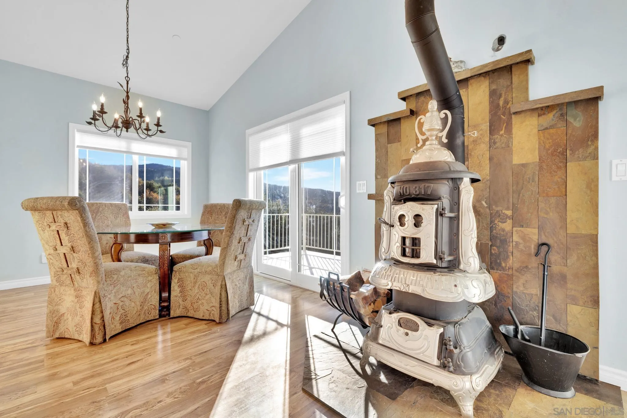 17735 Harrison Park Road Julian, CA 92036 - Photo 23 of 43 a living room with furniture a fireplace and a chandelier