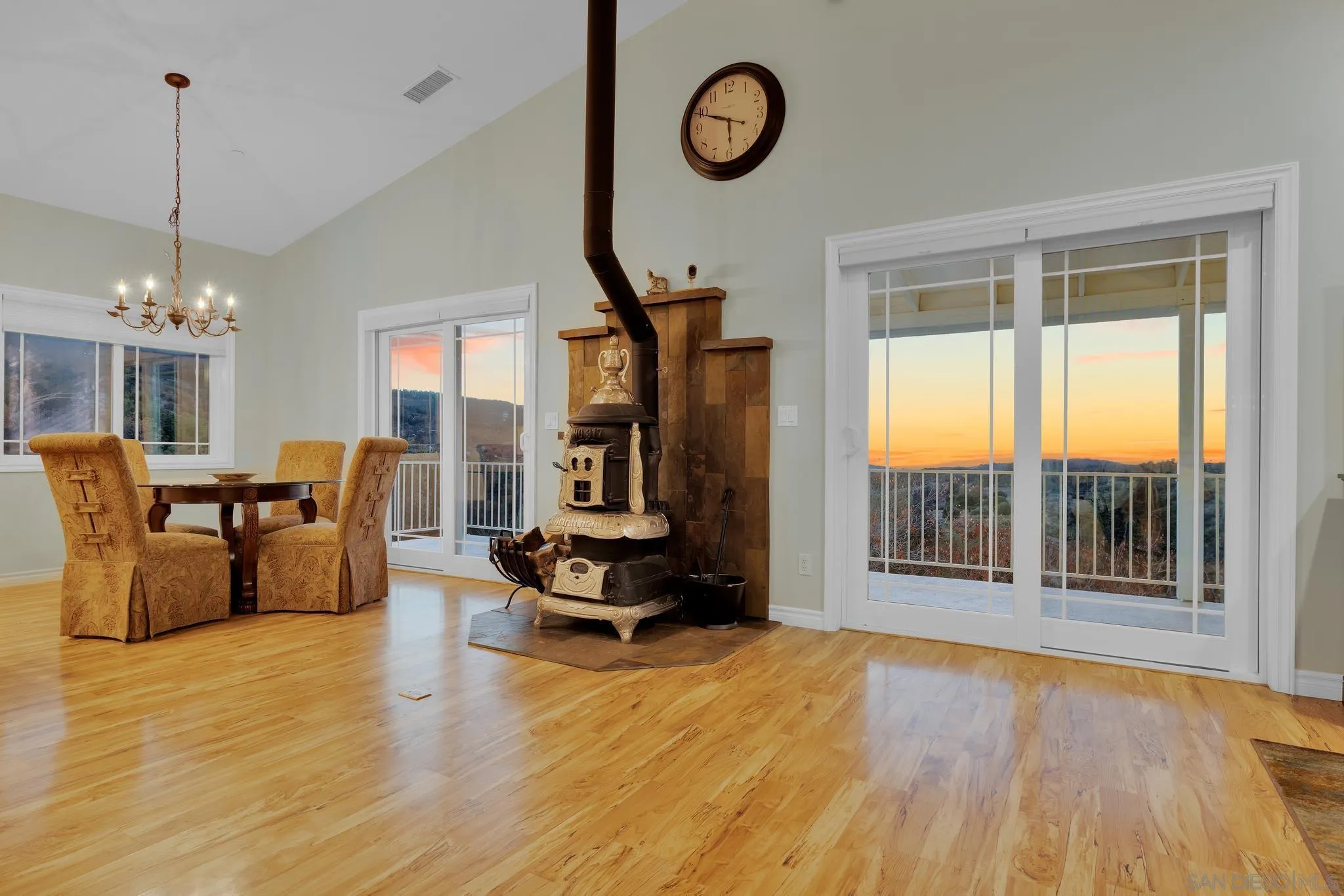 17735 Harrison Park Road Julian, CA 92036 - Photo 24 of 43 a living room with furniture a fireplace and a floor to ceiling window