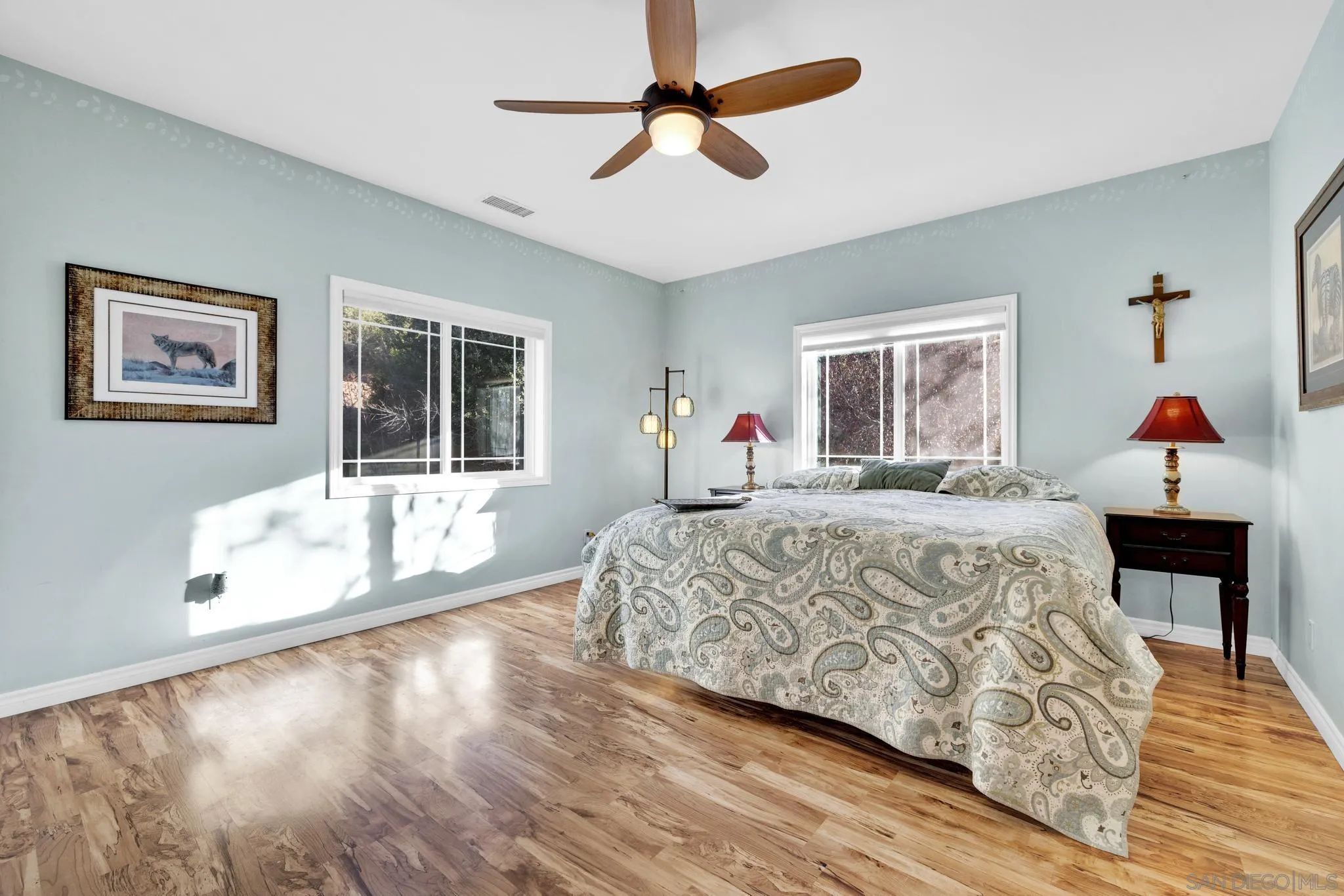 17735 Harrison Park Road Julian, CA 92036 - Photo 34 of 43 a bedroom with a large bed and a chandelier fan