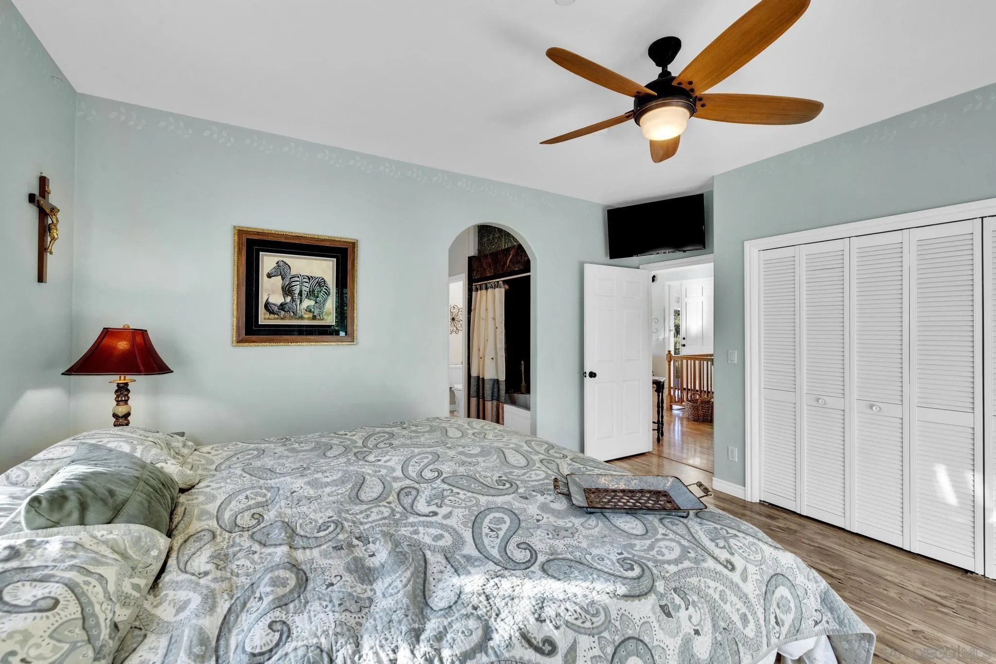 17735 Harrison Park Road Julian, CA 92036 - Photo 36 of 43 a bedroom with a bed and a chandelier