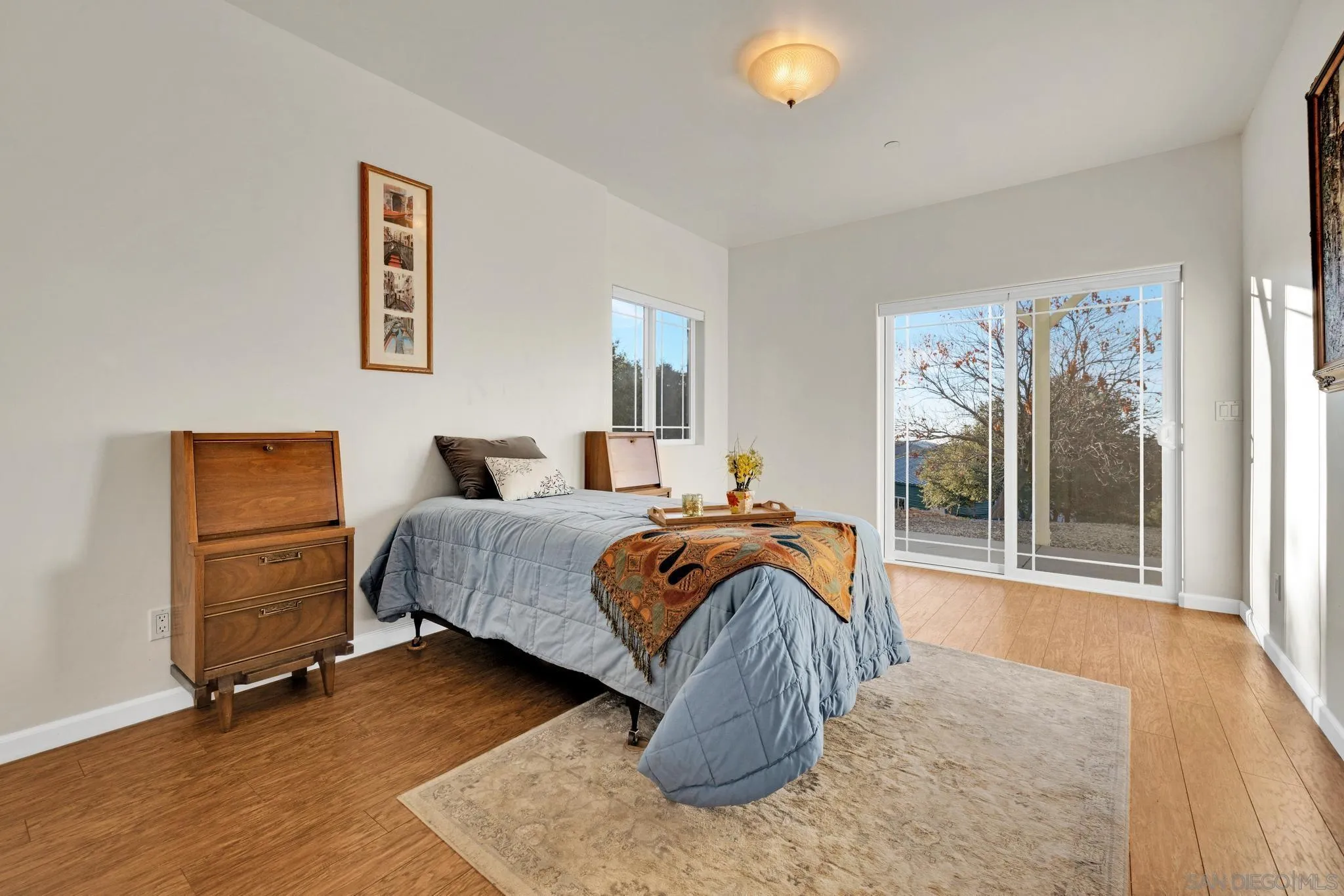 17735 Harrison Park Road Julian, CA 92036 - Photo 38 of 43 a bedroom with a bed and a painting on the wall