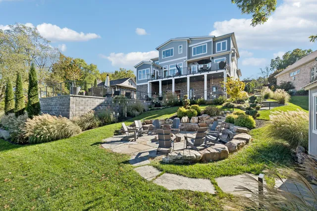 a front view of a house with a yard table and chairs