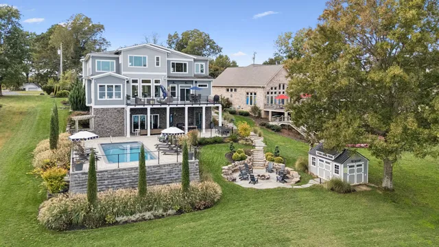 a front view of a house with a garden and trees