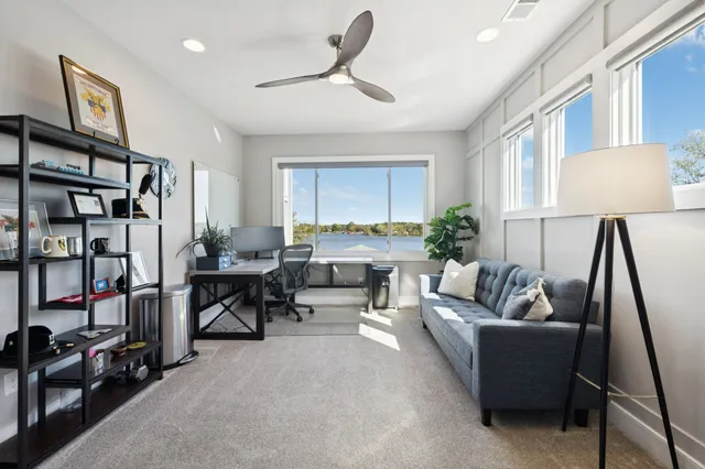 a bathroom with a bathtub and a potted plant