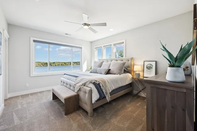 a spacious bedroom with a bed and a washing machine