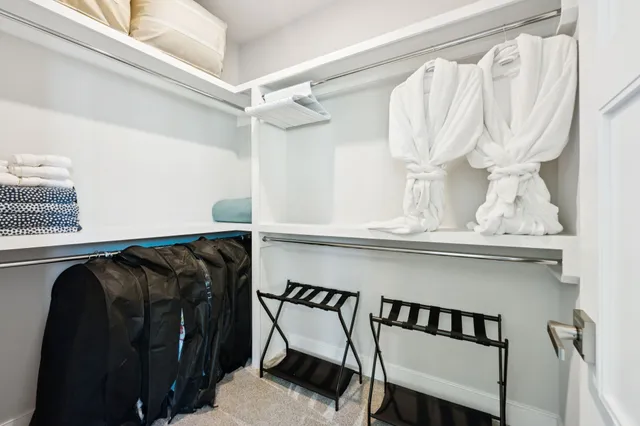 a living room with furniture a rug and a chandelier