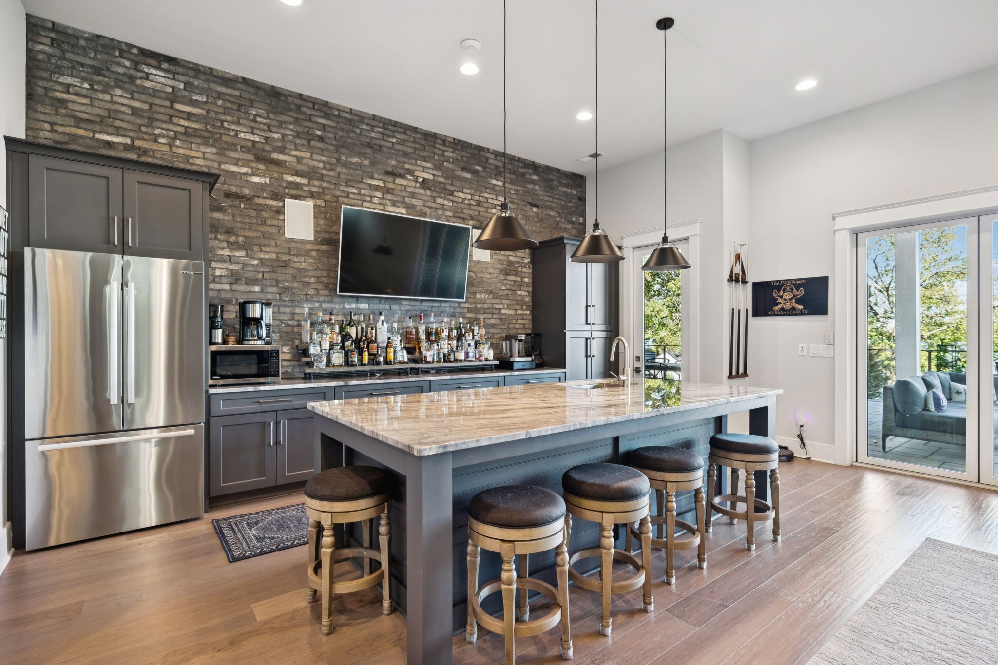 809 Burton Point Road Mount Juliet, TN 37122 - Photo 52 of 75 a kitchen with stainless steel appliances granite countertop a refrigerator a stove a sink a dining table and chairs with wooden floor