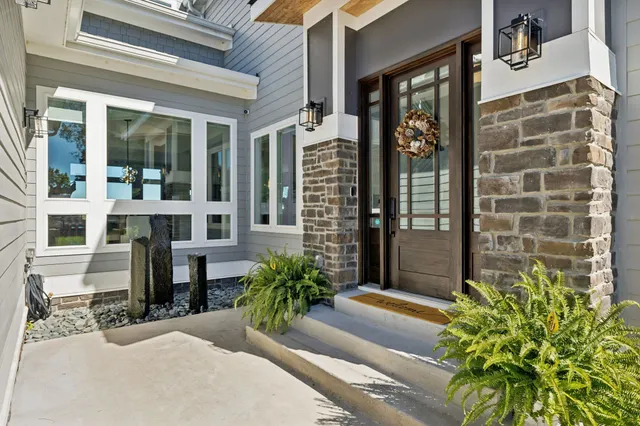a view of a dining room with furniture large windows and wooden floor