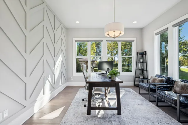 a kitchen with a large counter top space appliances and windows