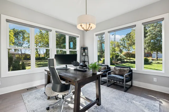 a kitchen with stainless steel appliances cabinets and wooden floor