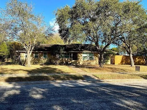 a view of a house with snow on the road