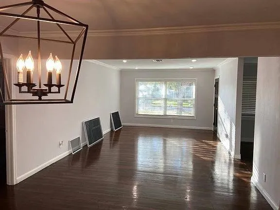 a view of a room with wooden floor and fan