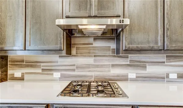 a kitchen with a stove and a cabinets