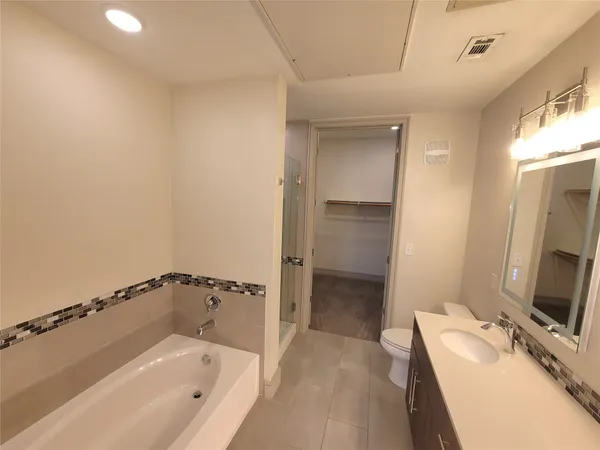 a bathroom with a bathtub and a sink
