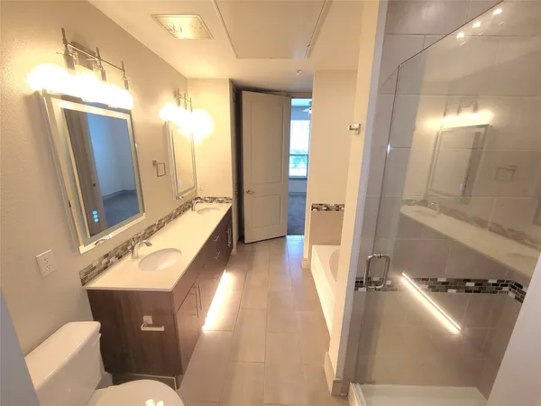 a bathroom with a sink mirror and toilet