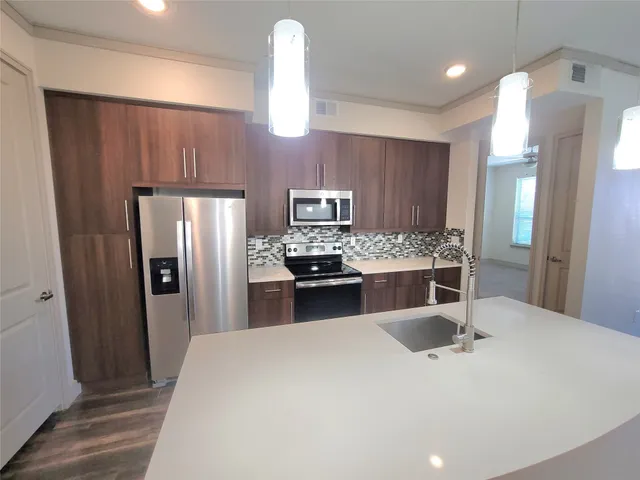 a kitchen with a refrigerator and a sink