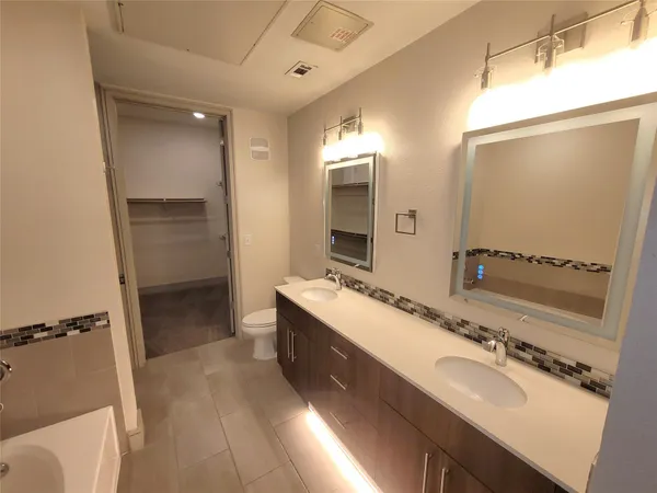 a bathroom with a double vanity sink and mirror