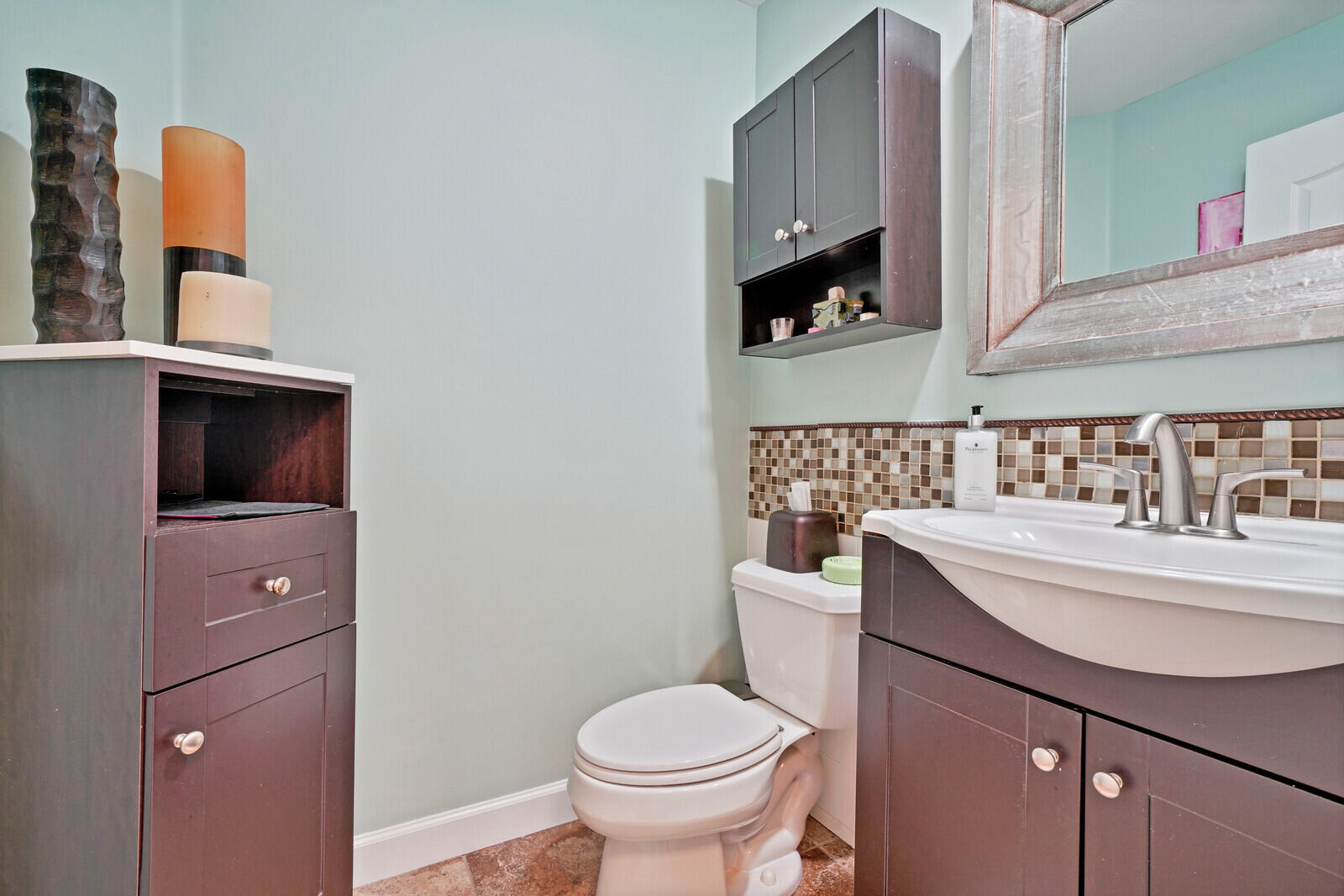 1615 Frederick Small Road Jupiter, FL 33458 - Photo 20 of 32 a bathroom with a sink a toilet and mirror