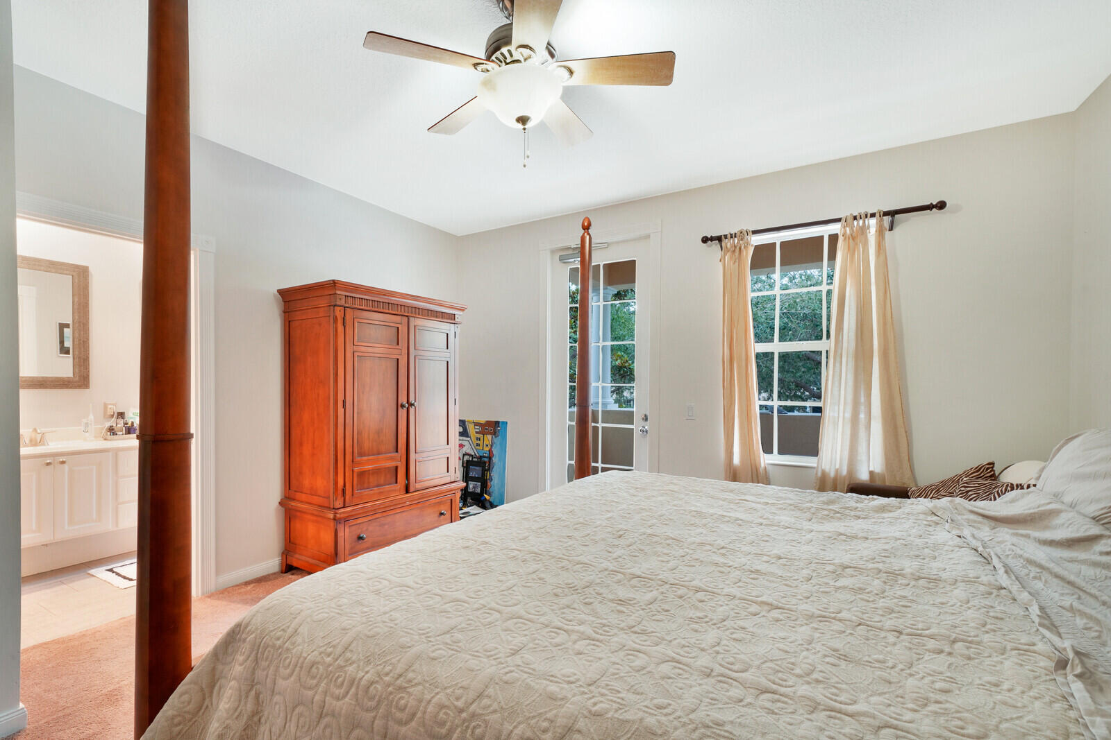 1615 Frederick Small Road Jupiter, FL 33458 - Photo 22 of 32 a bedroom with a large bed and a chandelier