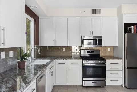 a kitchen with a sink stove and cabinets