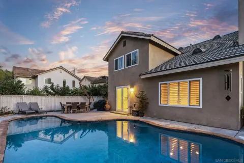 a house with swimming pool in front of it