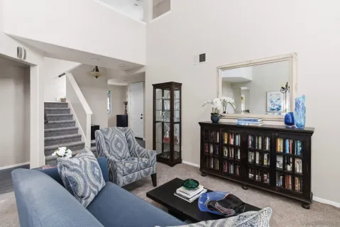 a living room with furniture and a wooden floor