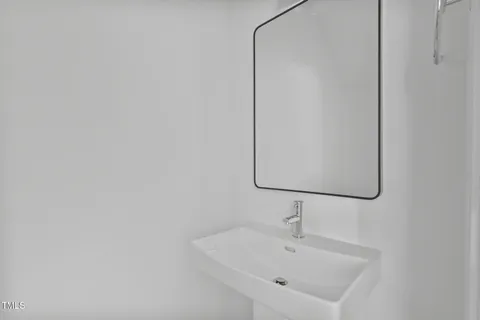 a bathroom with a sink and mirror