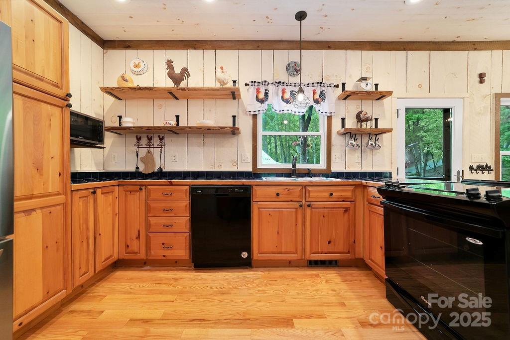 418 Sandy Lane Brevard, NC 28712 - Photo 20 of 45 a kitchen with stainless steel appliances granite countertop a stove a sink and a microwave