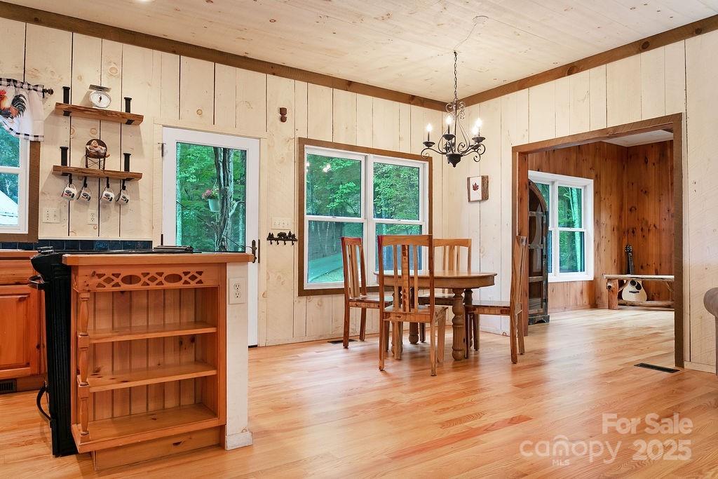 418 Sandy Lane Brevard, NC 28712 - Photo 23 of 45 a view of a dining room with furniture window and wooden floor