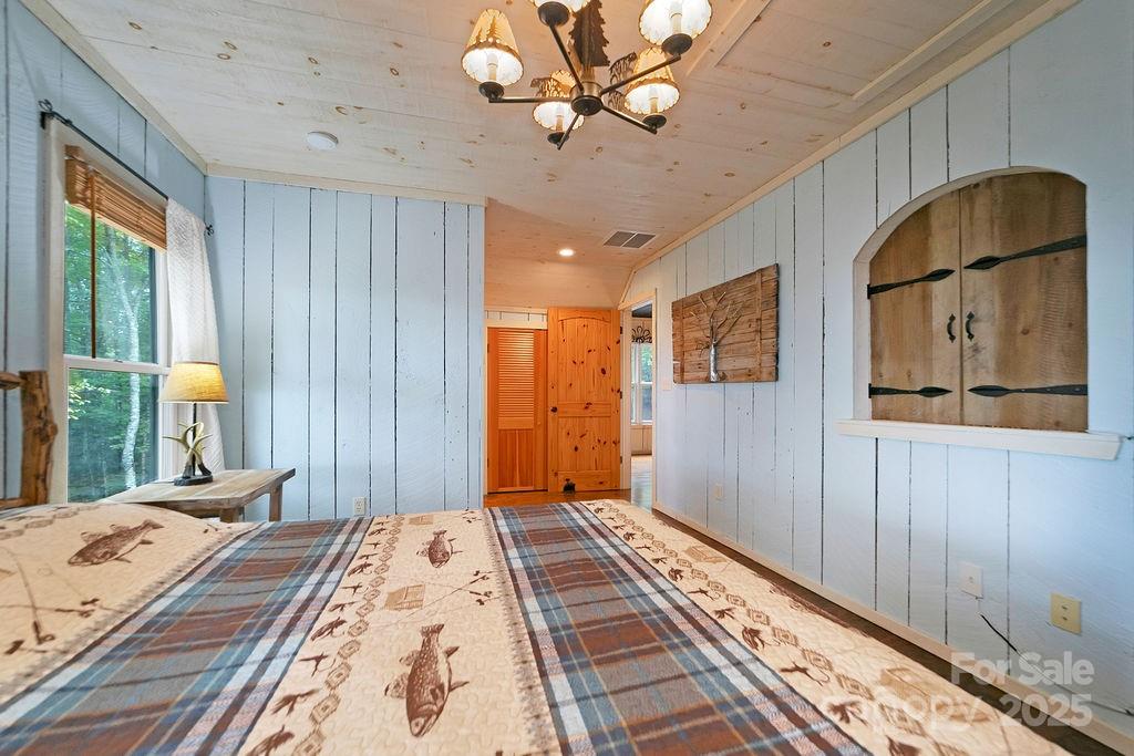 418 Sandy Lane Brevard, NC 28712 - Photo 35 of 45 a bedroom with bed and wooden floor