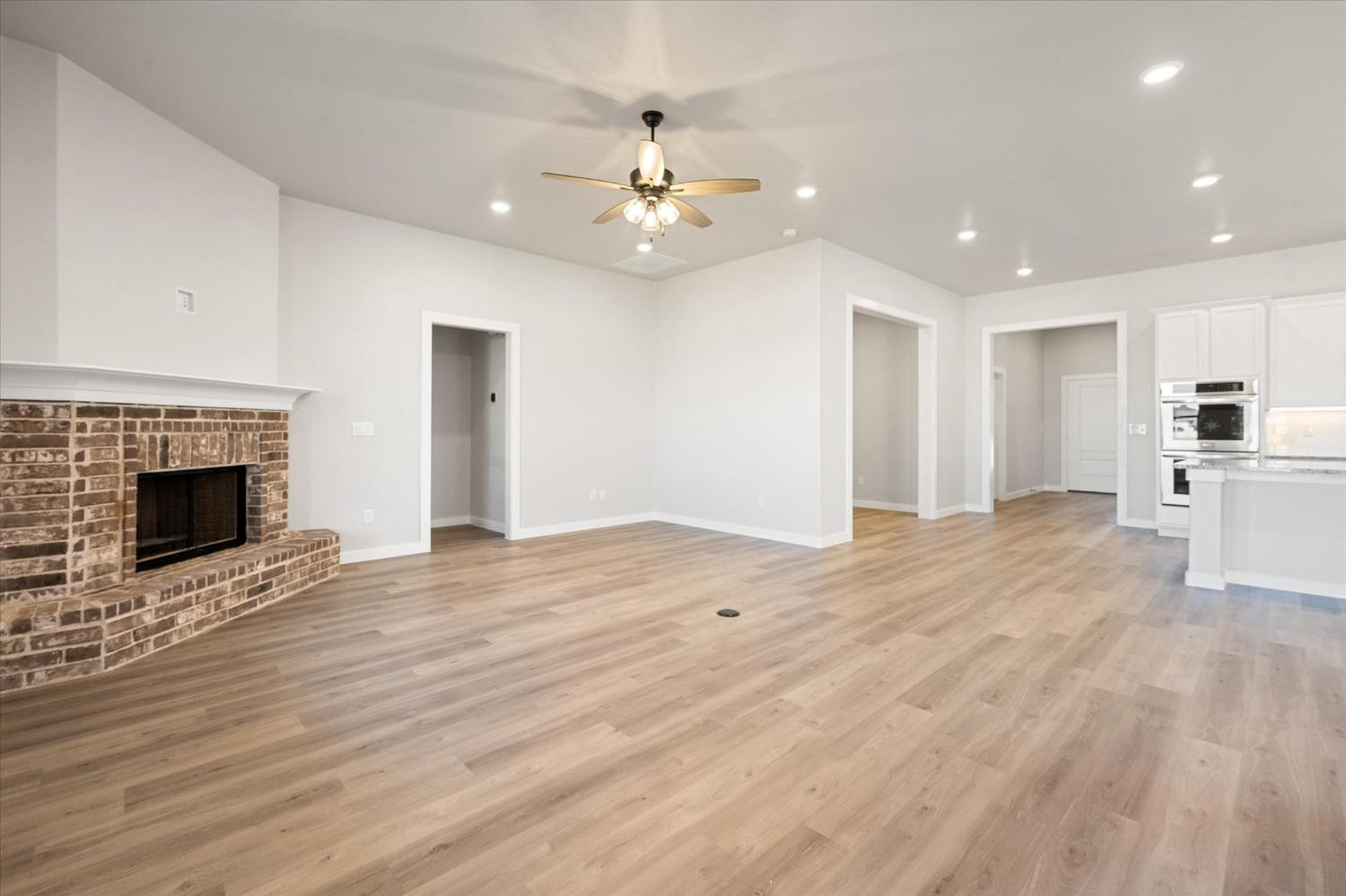 7426 30th Street Lubbock, TX 79407 - Photo 11 of 25 a view of an empty room with wooden floor fireplace and a window