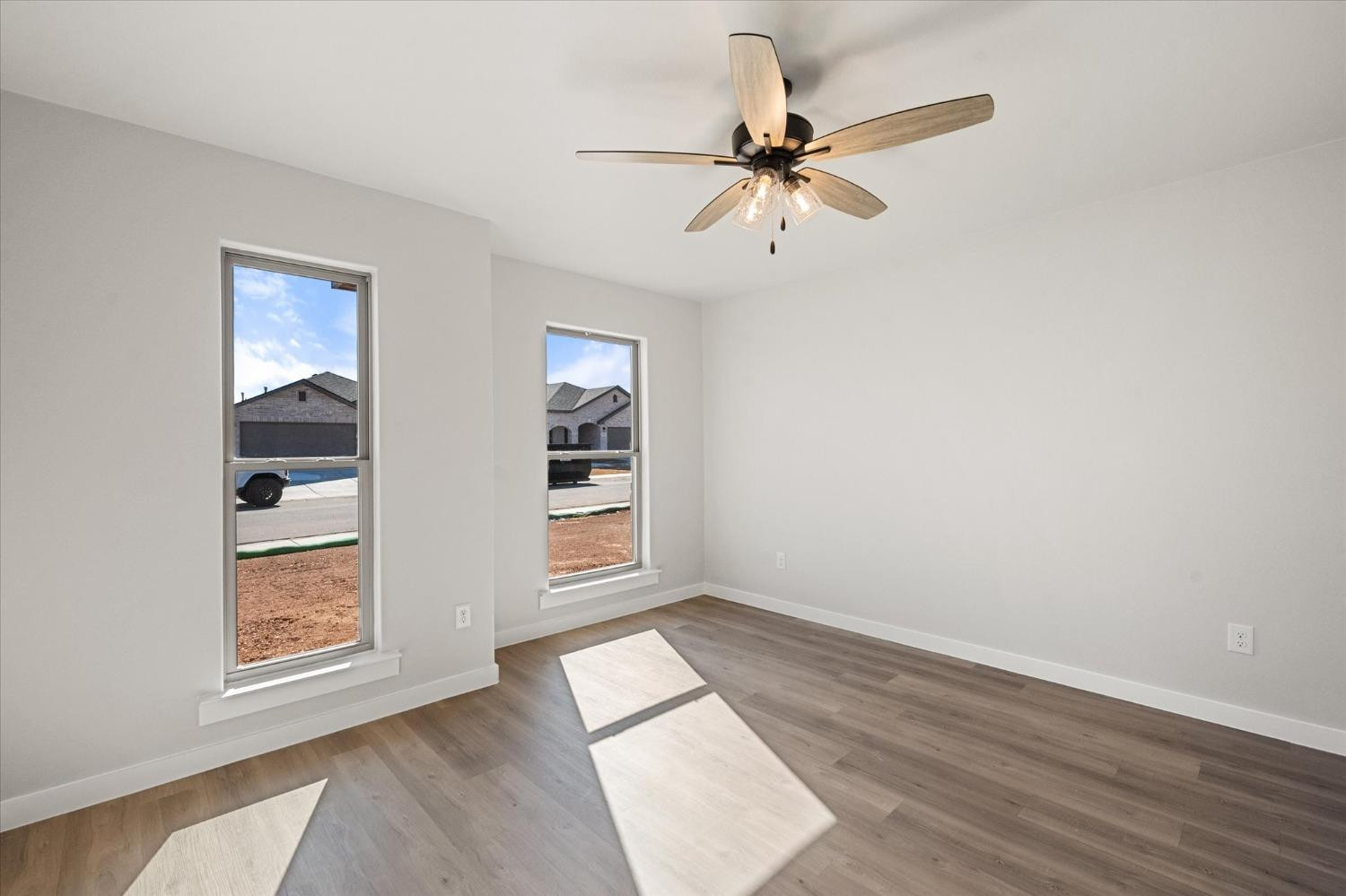 7426 30th Street Lubbock, TX 79407 - Photo 19 of 25 an empty room with windows and fan