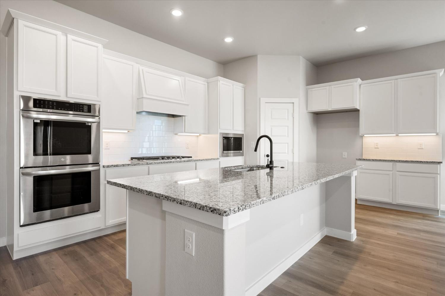 7426 30th Street Lubbock, TX 79407 - Photo 4 of 25 a kitchen with stainless steel appliances granite countertop a sink stove and microwave